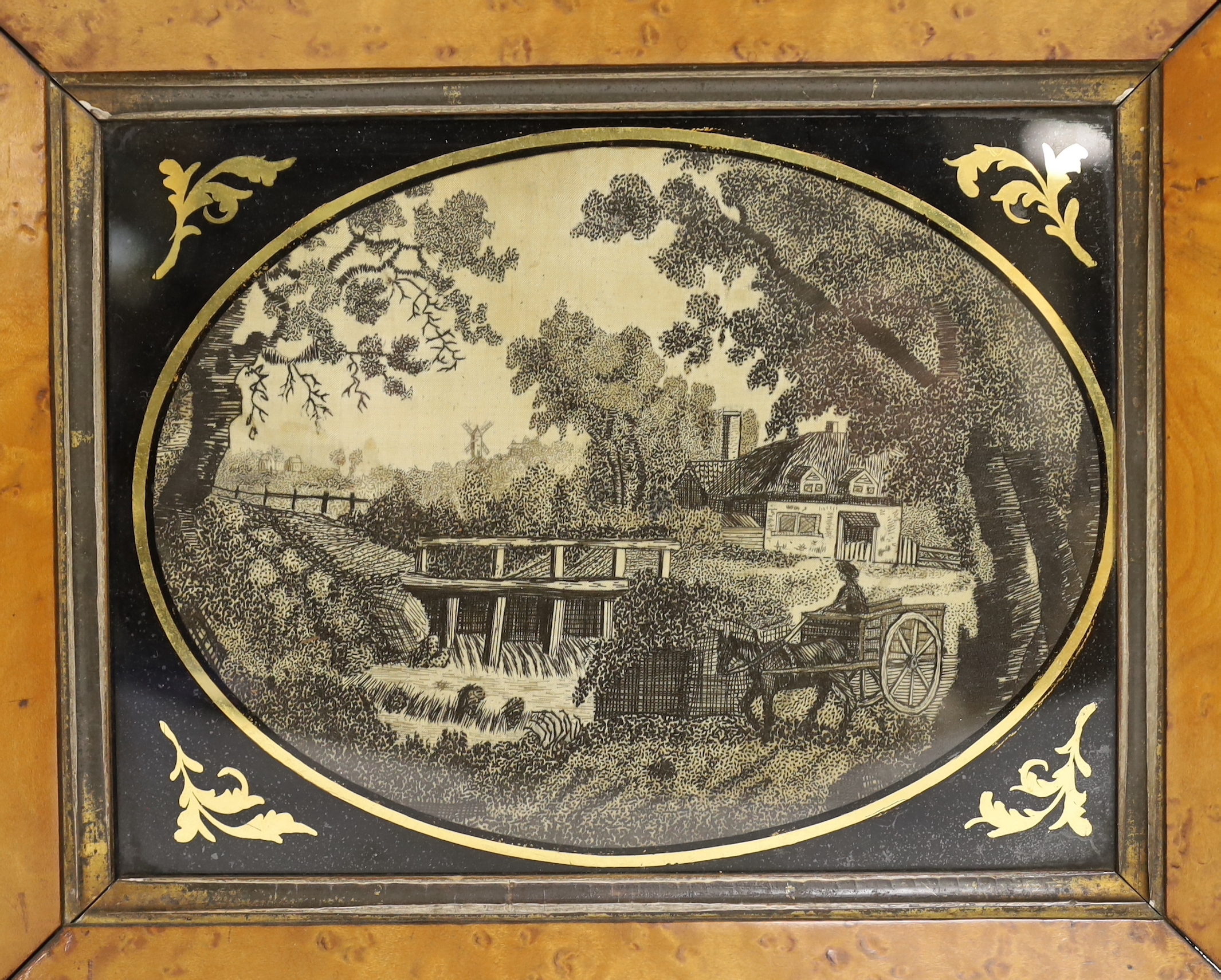 A pair of maple framed and oval verre eglomise glass Regency black silk embroidered pictorial landscape panels, 19cm wide x 14cm high